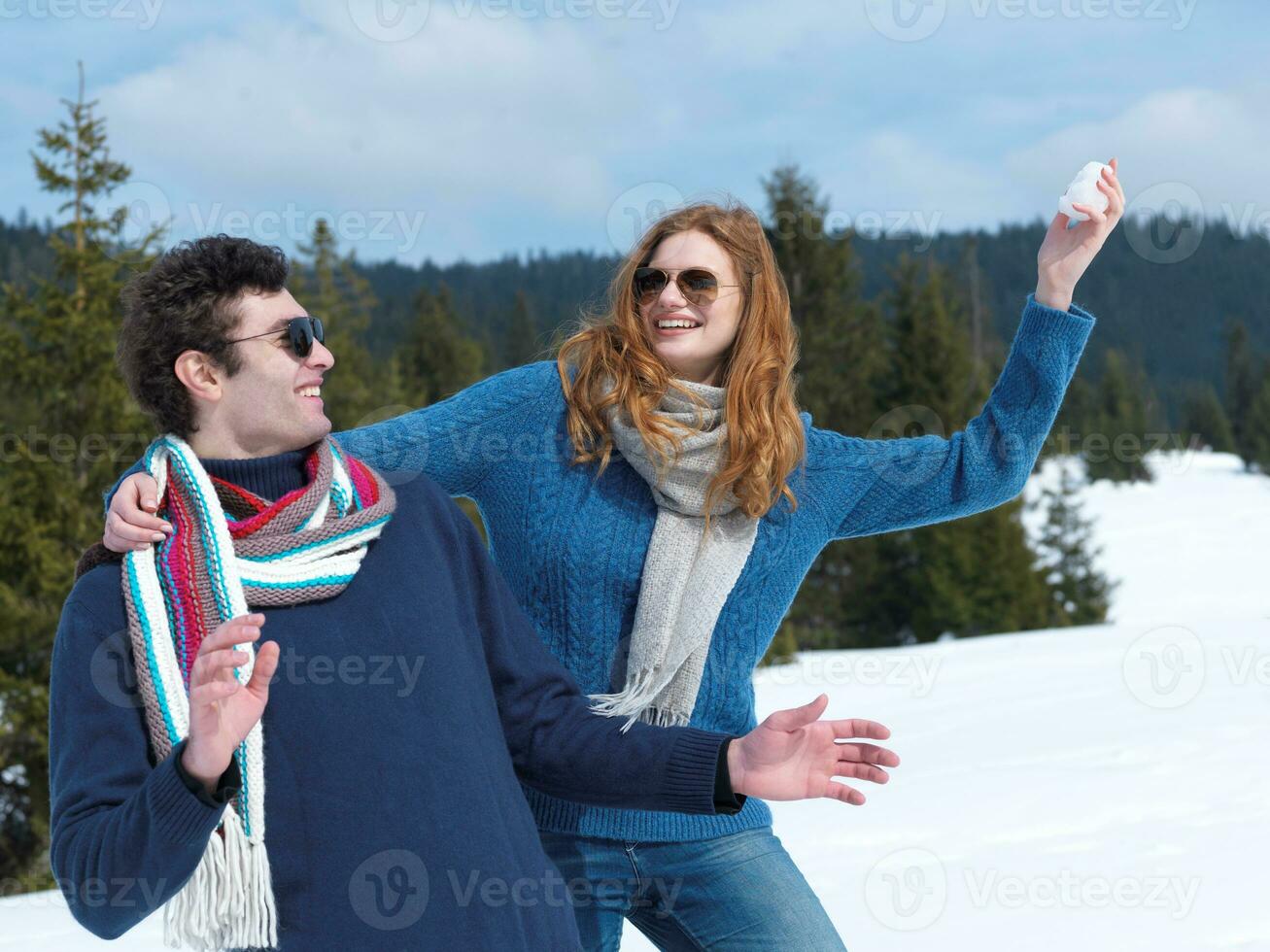 happy young couple having fun on fresh show on winter vacation photo