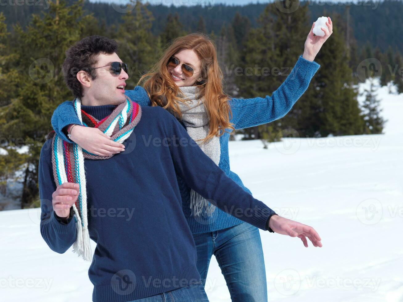 happy young couple having fun on fresh show on winter vacation photo
