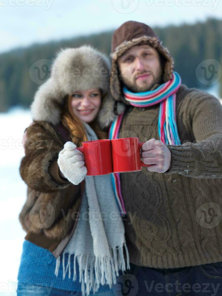 happy young couple drink warm tea at winter photo