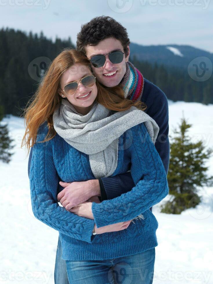 happy young couple having fun on fresh show on winter vacation photo