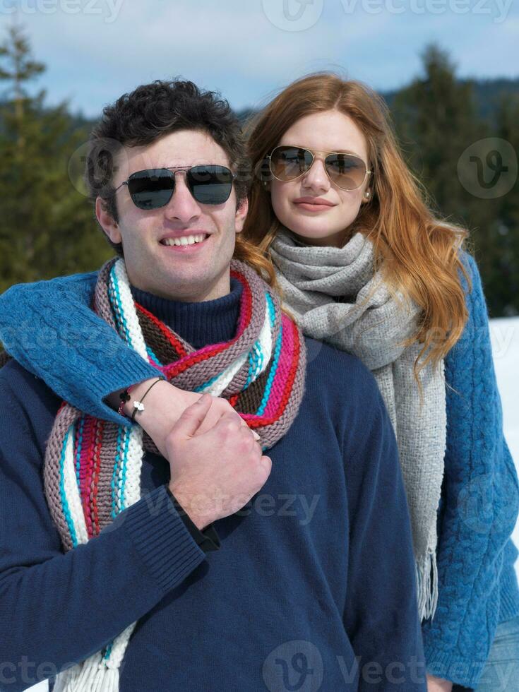 happy young couple having fun on fresh show on winter vacation photo