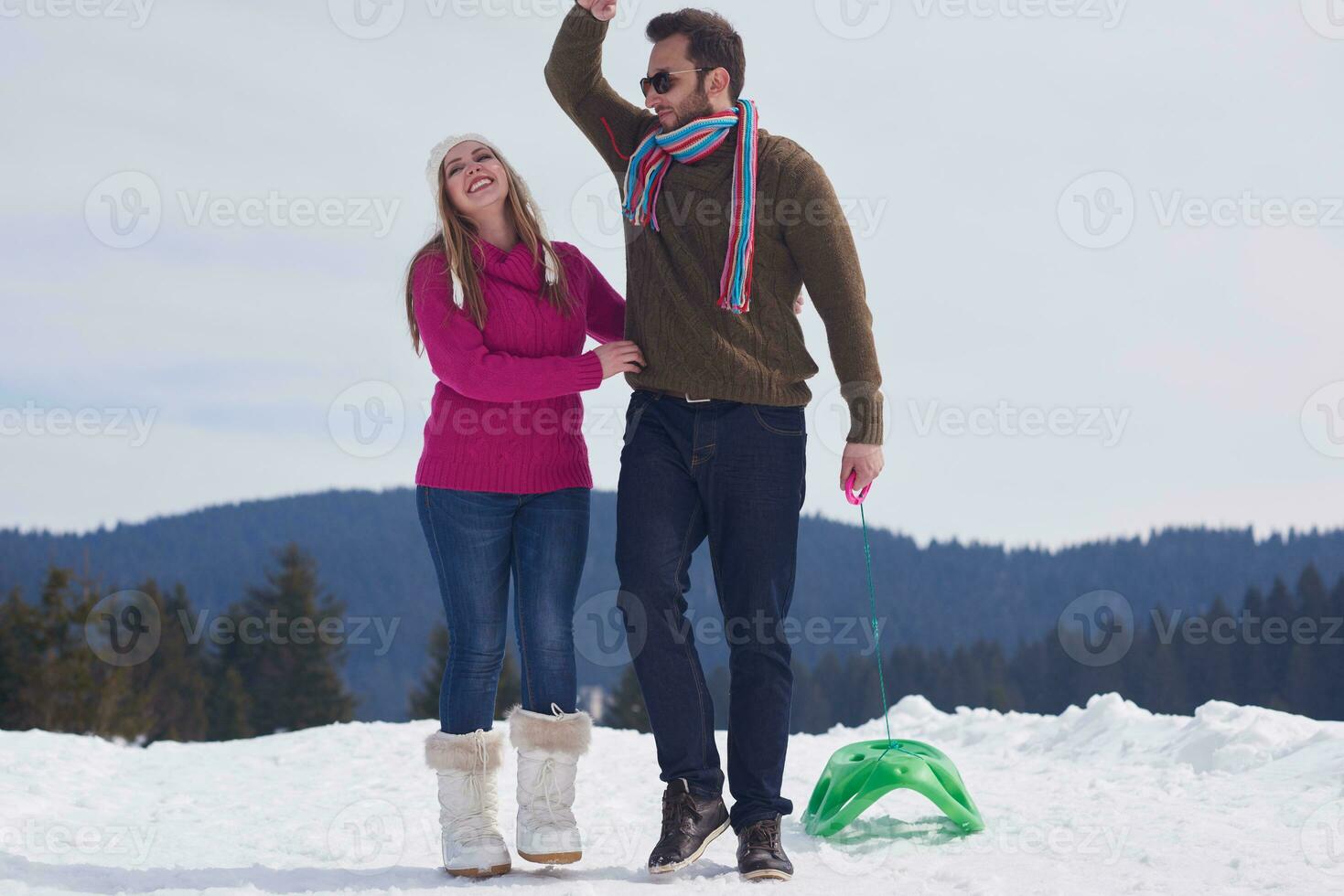 happy young couple having fun on fresh show on winter vacation photo