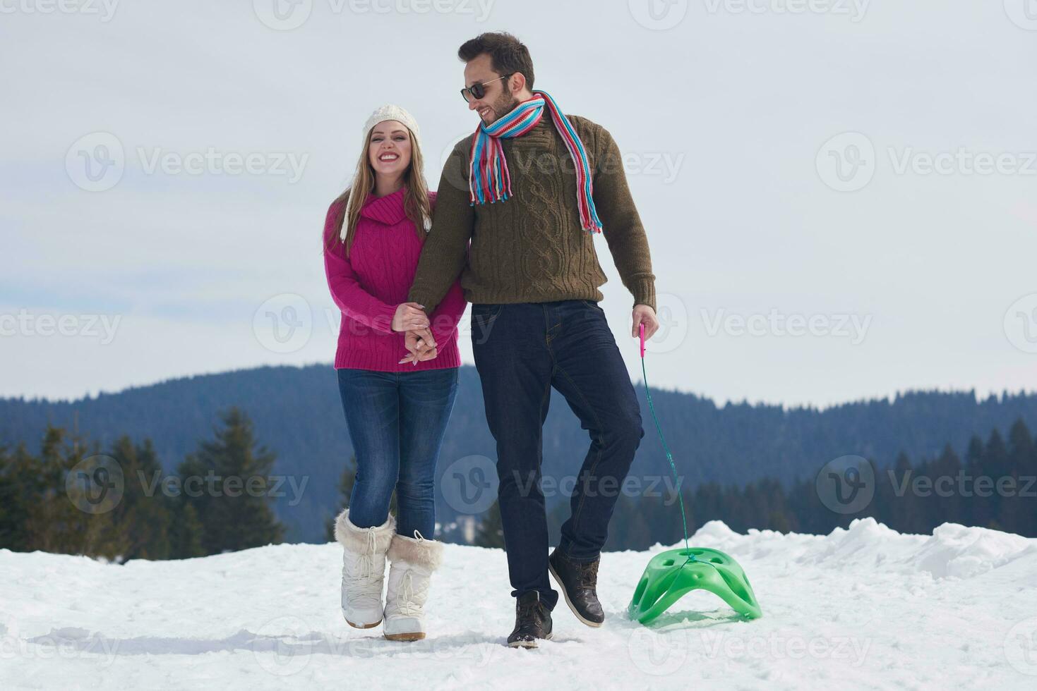 happy young couple having fun on fresh show on winter vacation photo