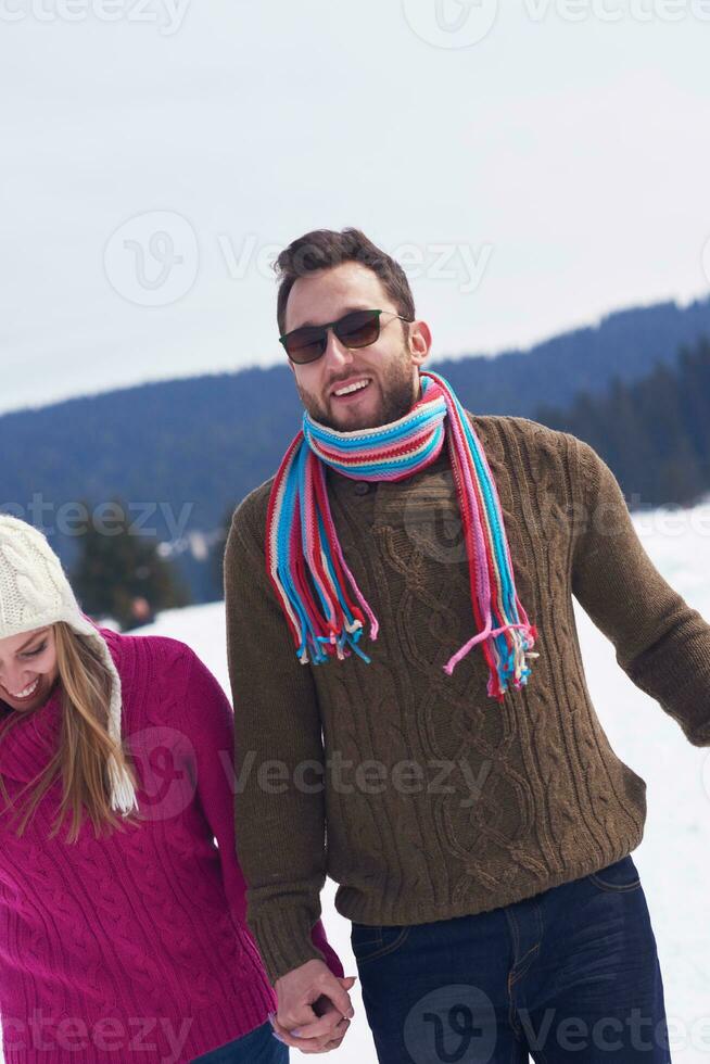 happy young couple having fun on fresh show on winter vacation photo