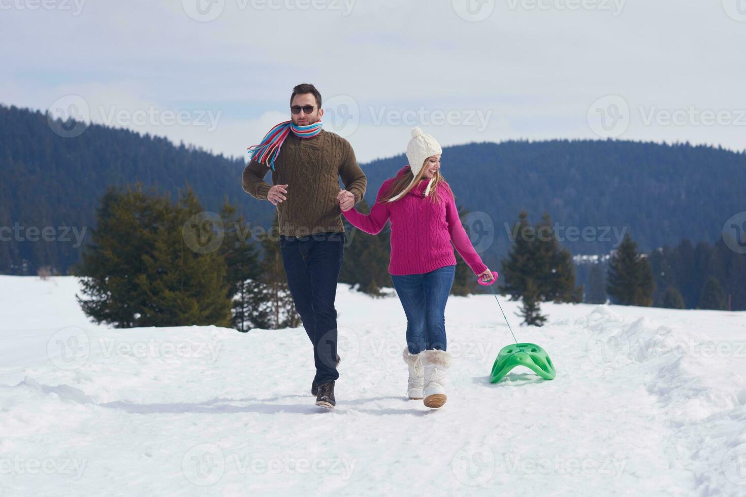 happy young couple having fun on fresh show on winter vacation photo