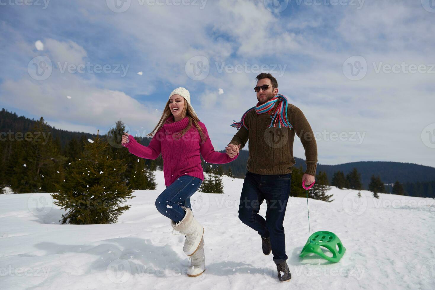 happy young couple having fun on fresh show on winter vacation photo