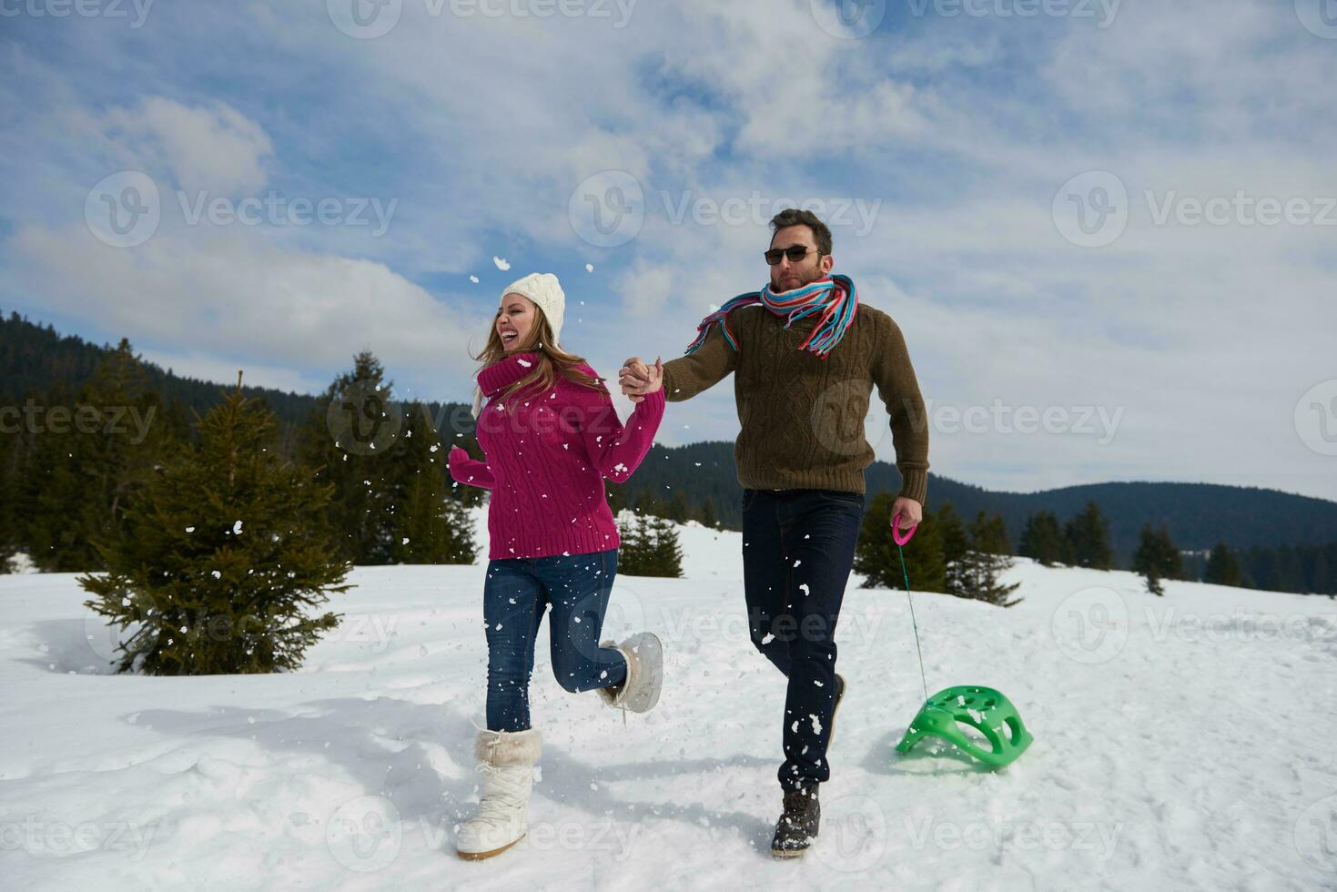 happy young couple having fun on fresh show on winter vacation photo