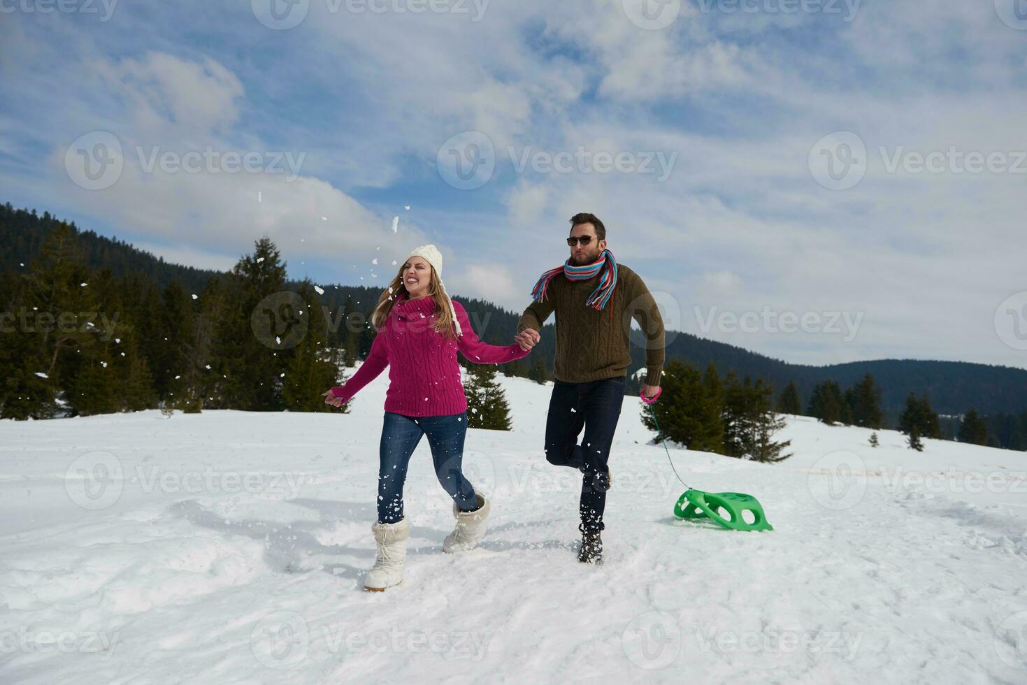 happy young couple having fun on fresh show on winter vacation photo