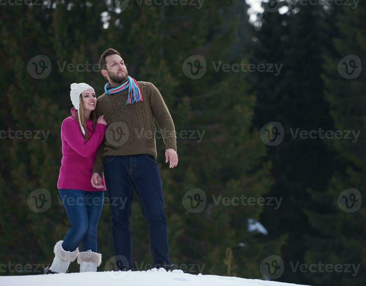 couple having fun and walking in snow shoes photo