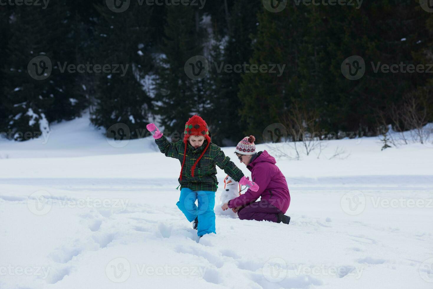 happy family building snowman photo