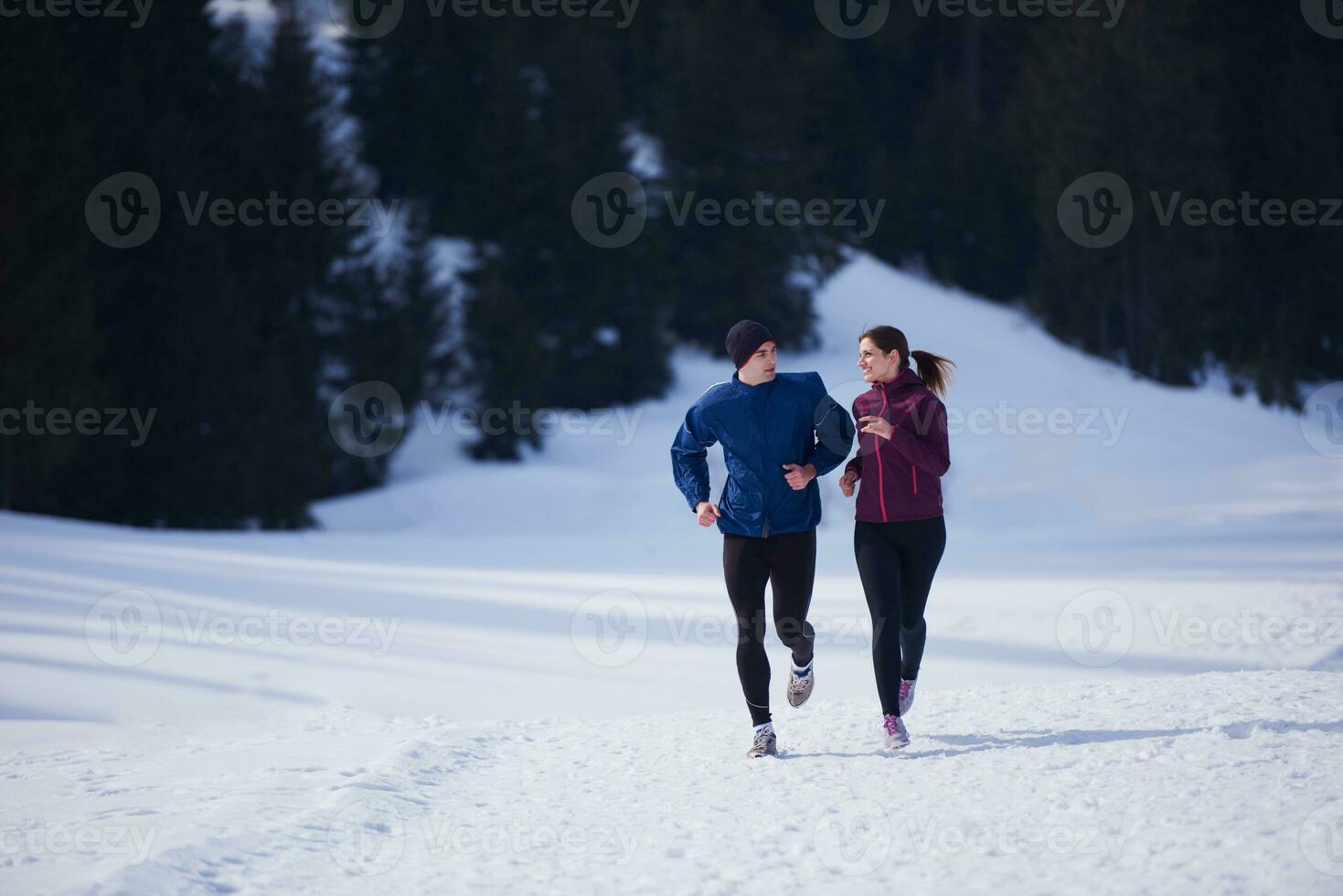 couple jogging outside on snow photo