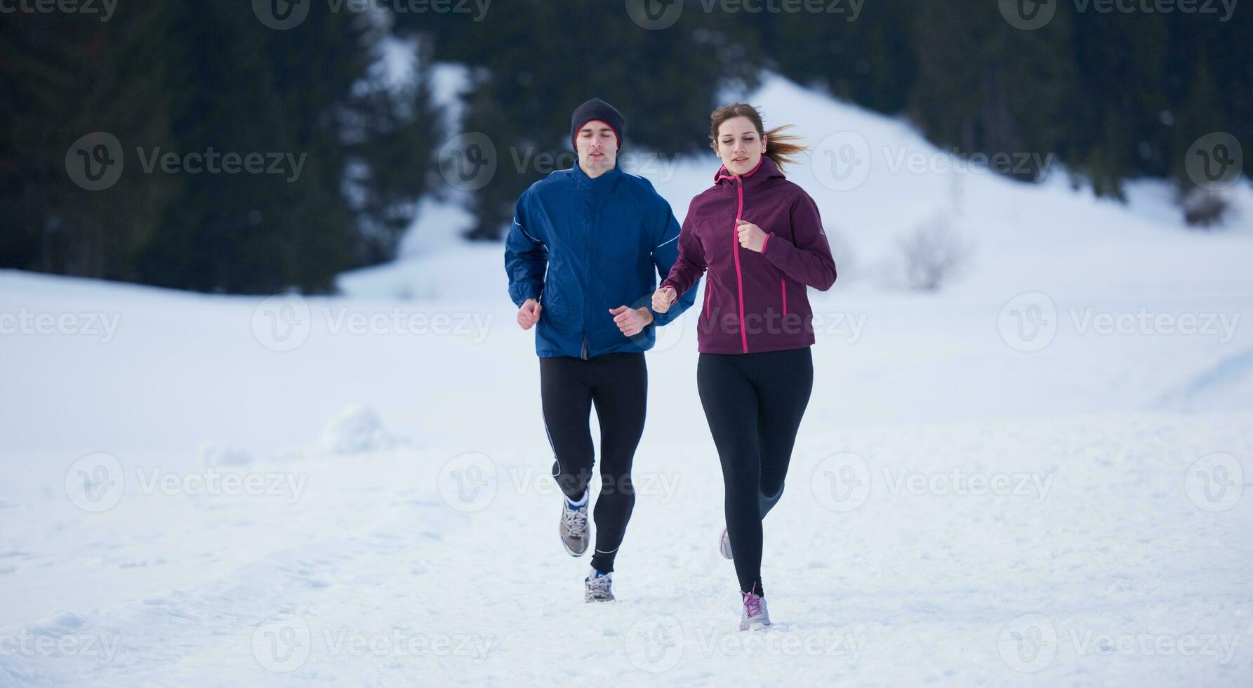 couple jogging outside on snow photo