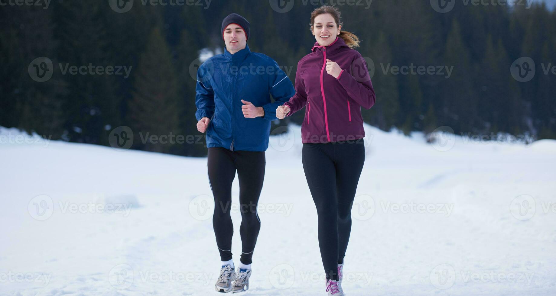 couple jogging outside on snow photo