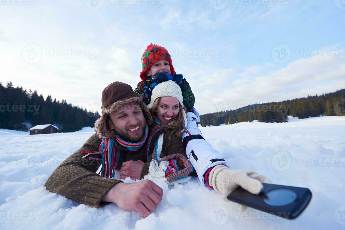 pareja romántica divertirse en la nieve fresca y tomar selfie foto
