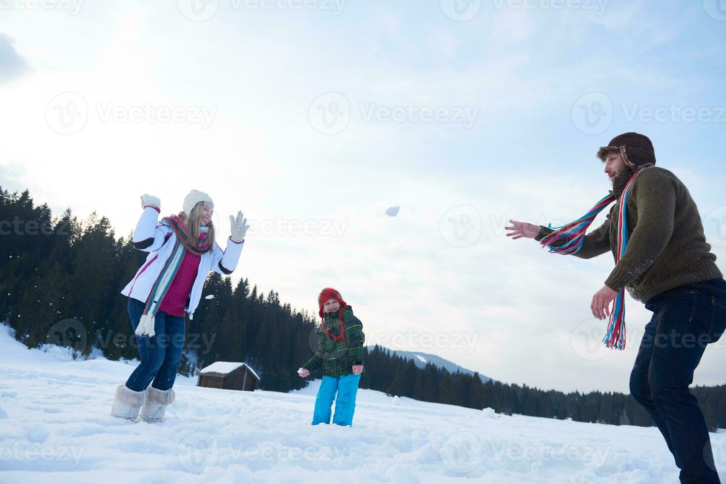 happy family playing together in snow at winter photo