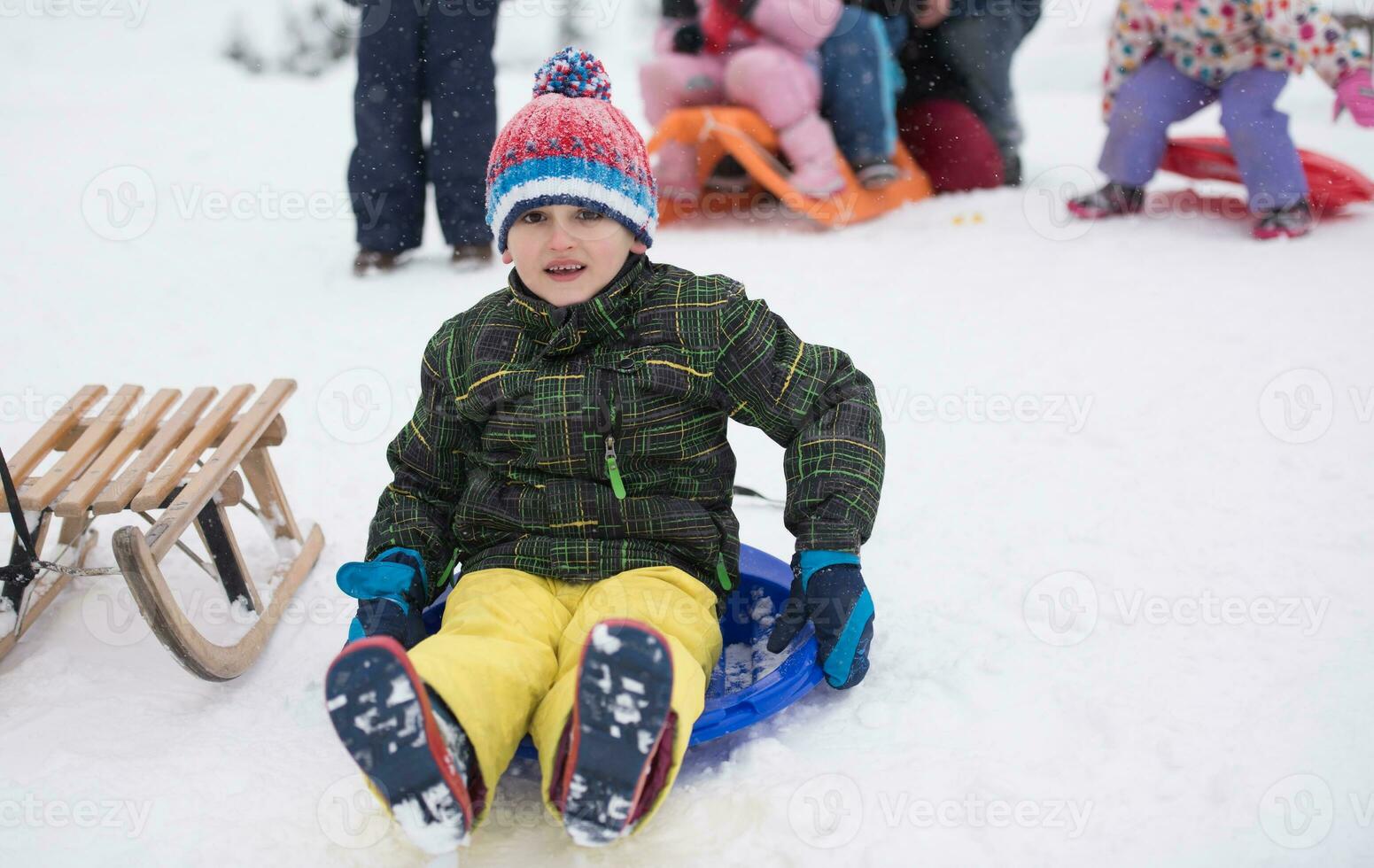 children group  having fun and play together in fresh snow photo
