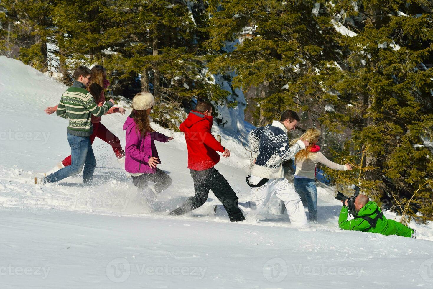 friends have fun at winter on fresh snow photo