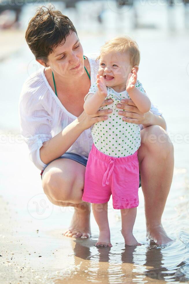 mom and baby on beach  have fun photo