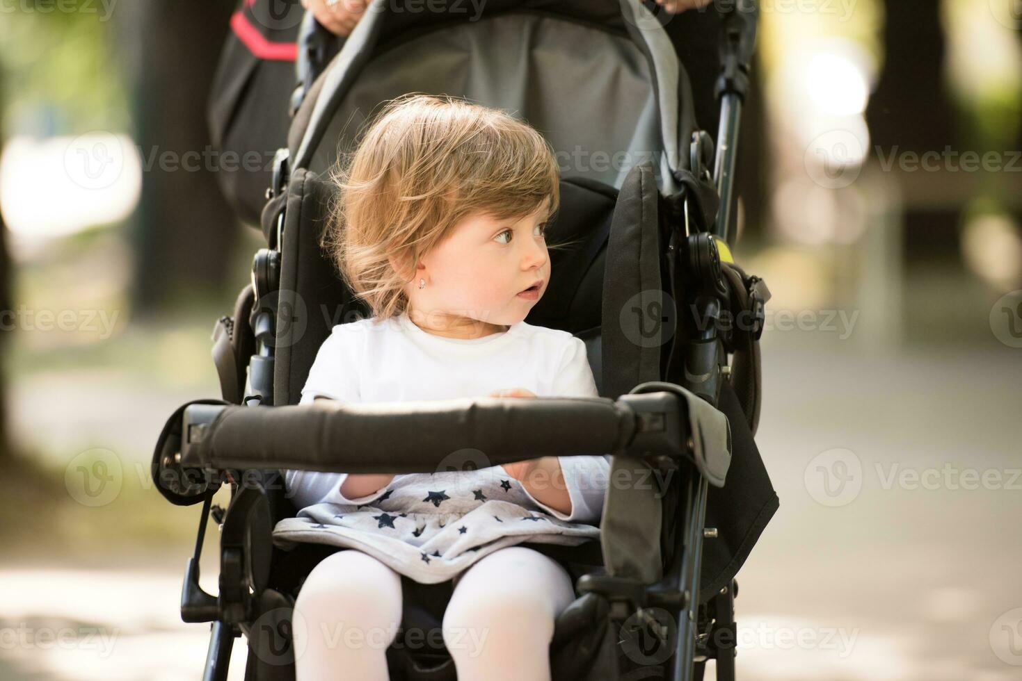 baby girl sitting in the pram photo