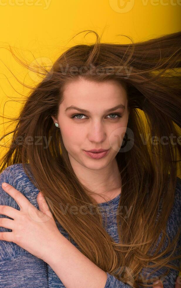 pretty woman playing with her long silky hair photo