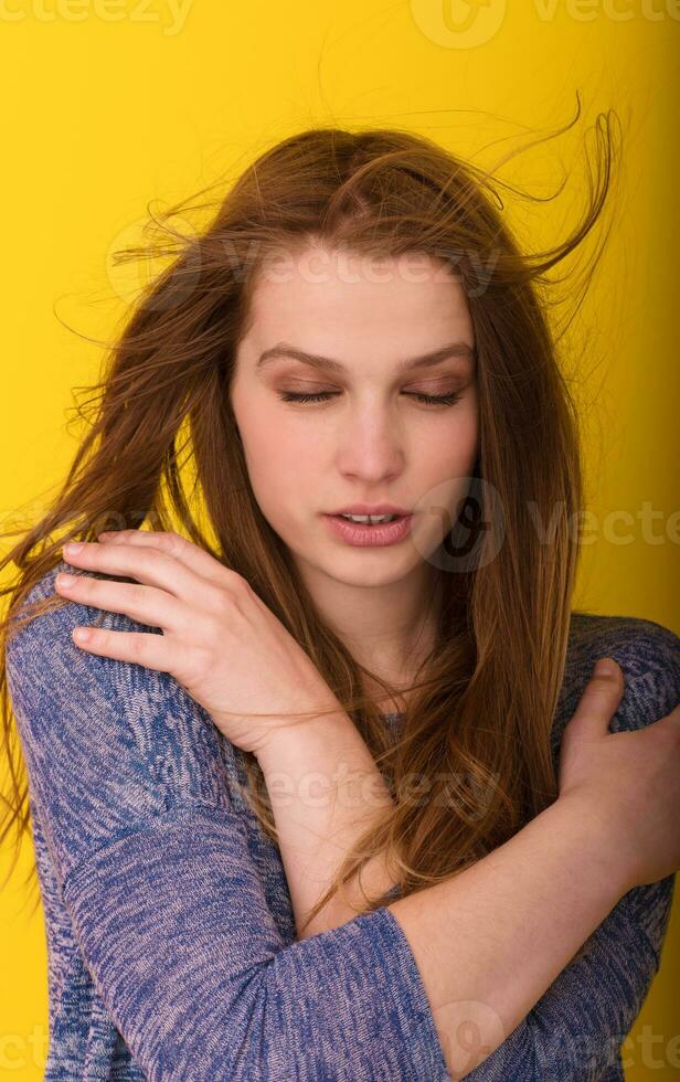 pretty woman playing with her long silky hair photo