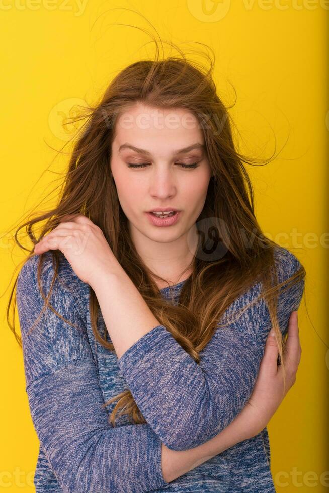 pretty woman playing with her long silky hair photo