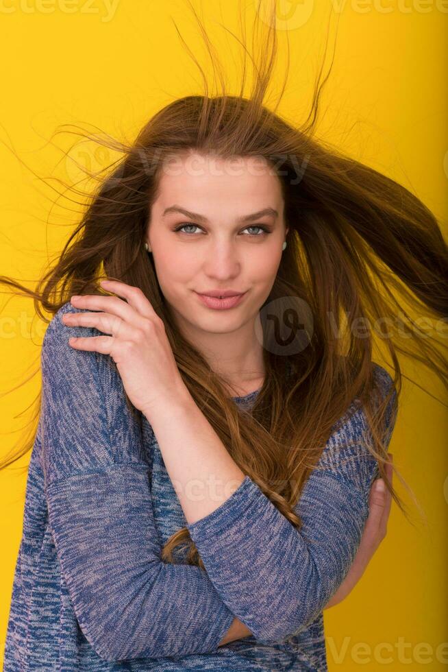 pretty woman playing with her long silky hair photo