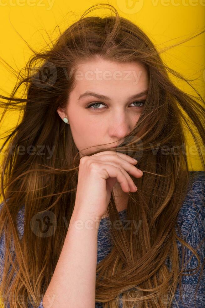 pretty woman playing with her long silky hair photo