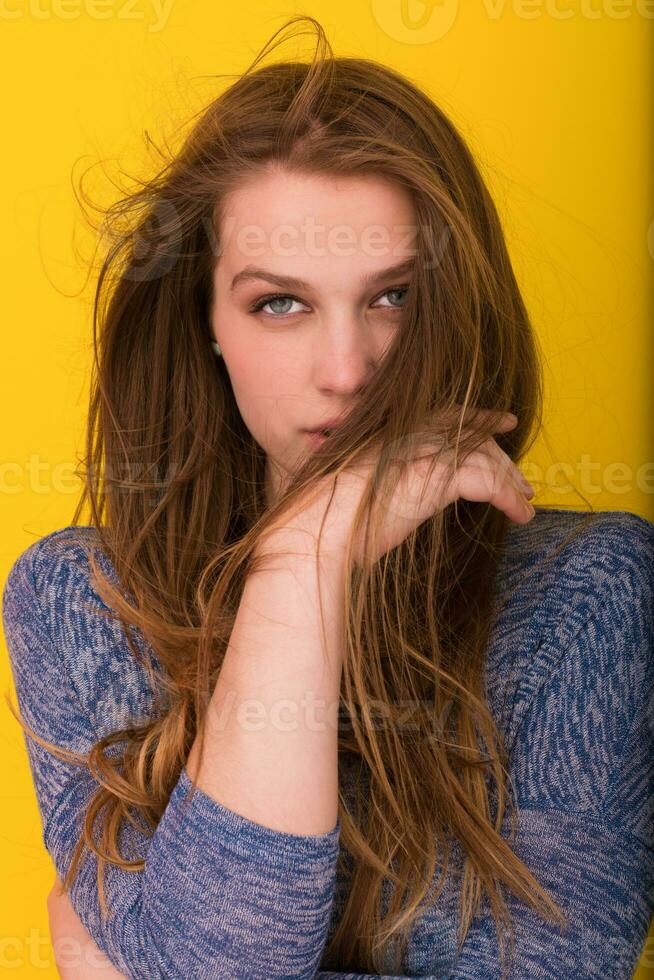 pretty woman playing with her long silky hair photo