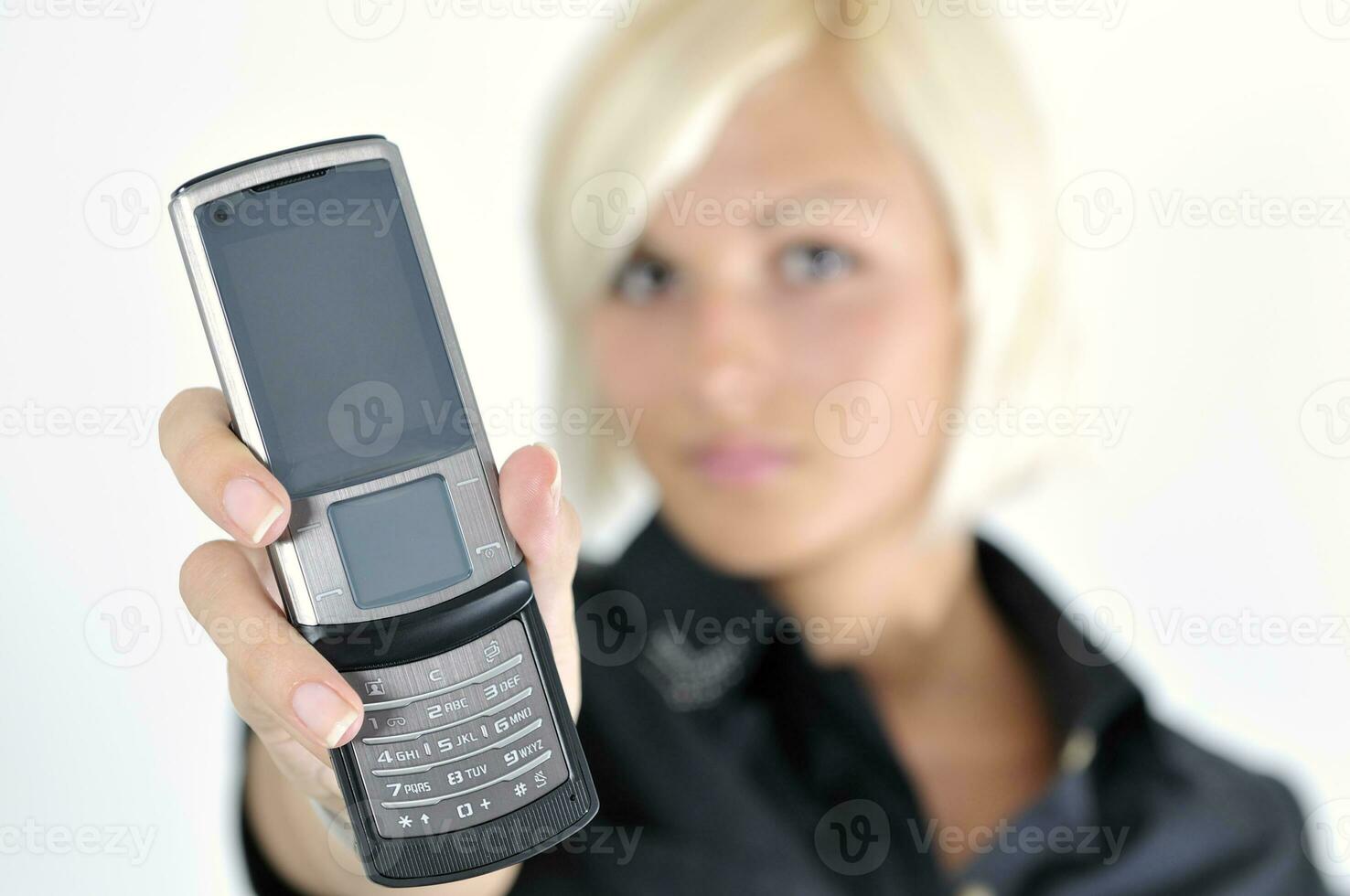 portrait of young blonde business woman holding new modern cellp photo