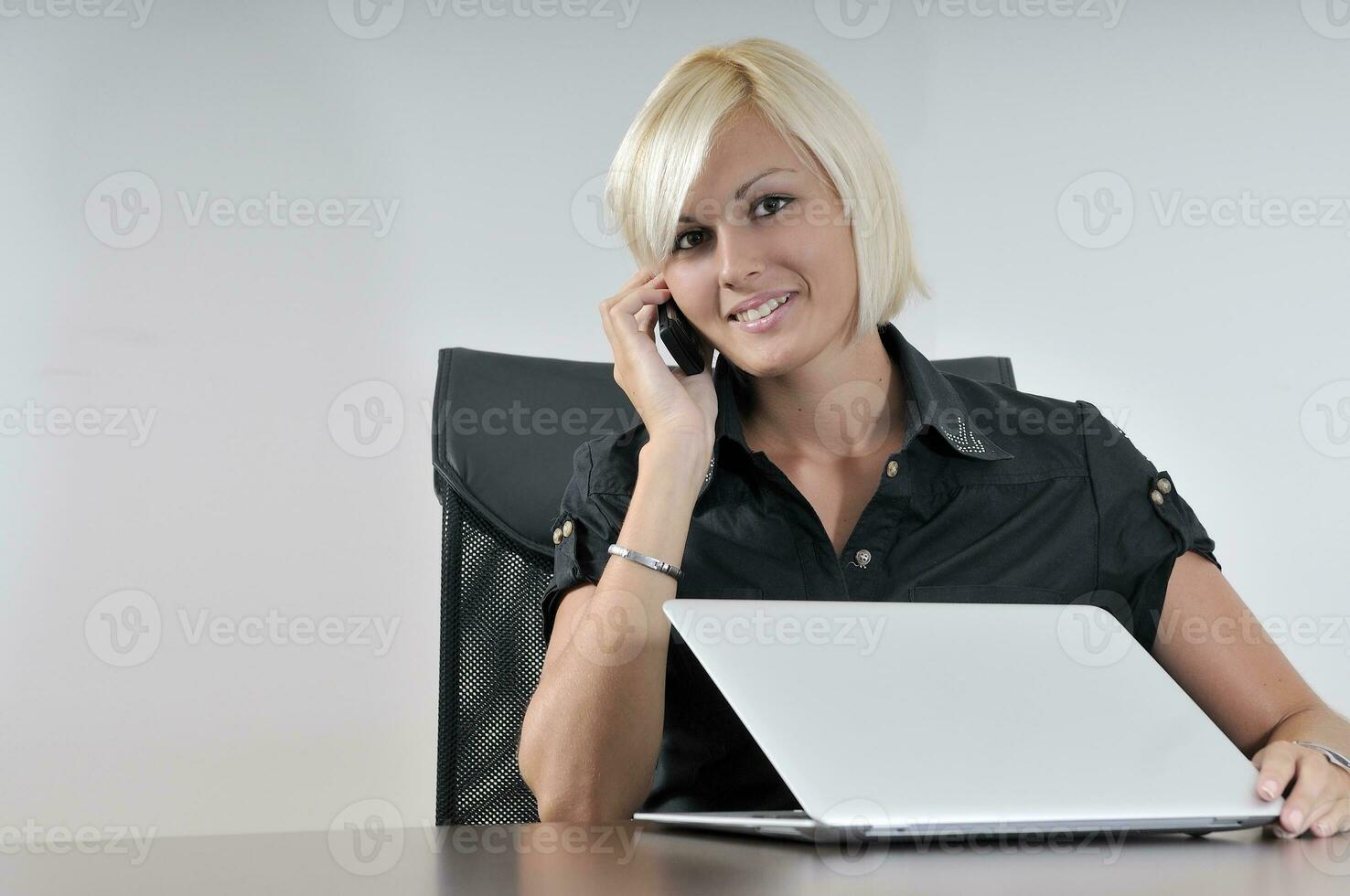 young business woman working in office on laptop photo