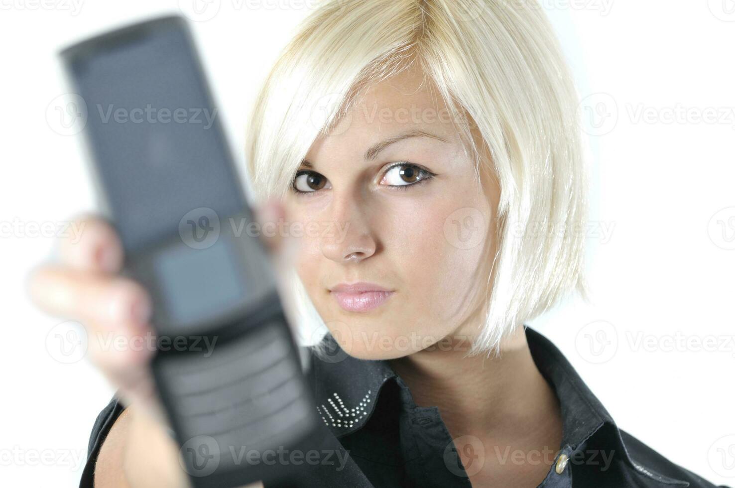 portrait of young blonde business woman holding new modern cellp photo