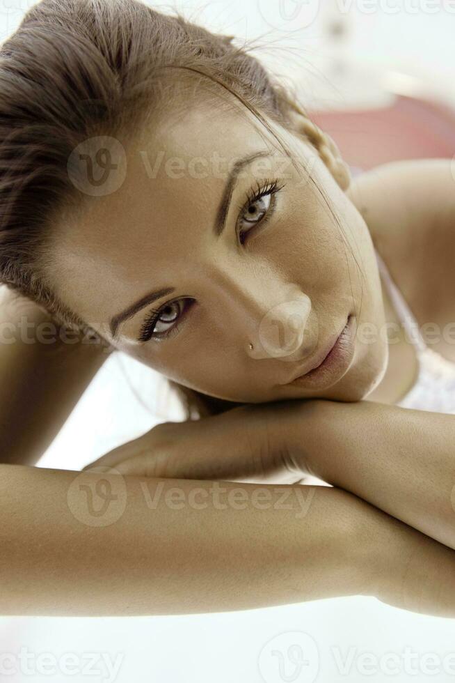 Beautiful young woman tanning in solarium photo