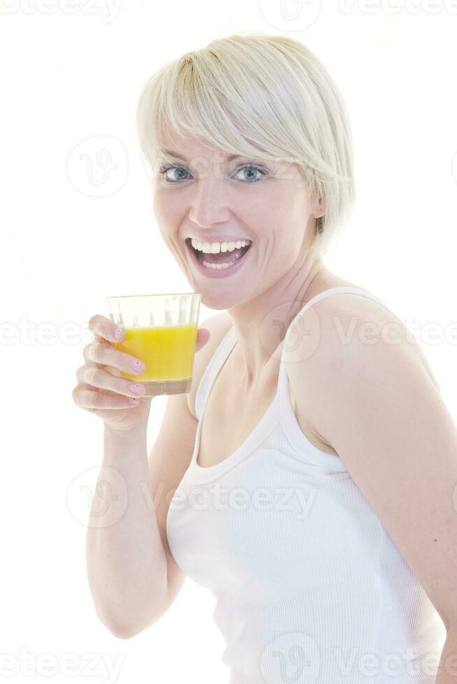 Young woman drinking orange juice isolated over white background photo