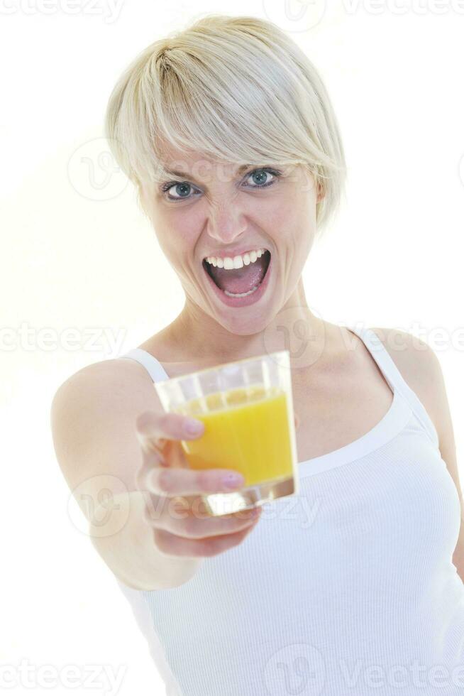 Young woman drinking orange juice isolated over white background photo