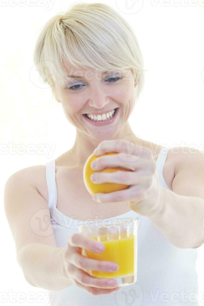 Young woman squeeze orange juice photo