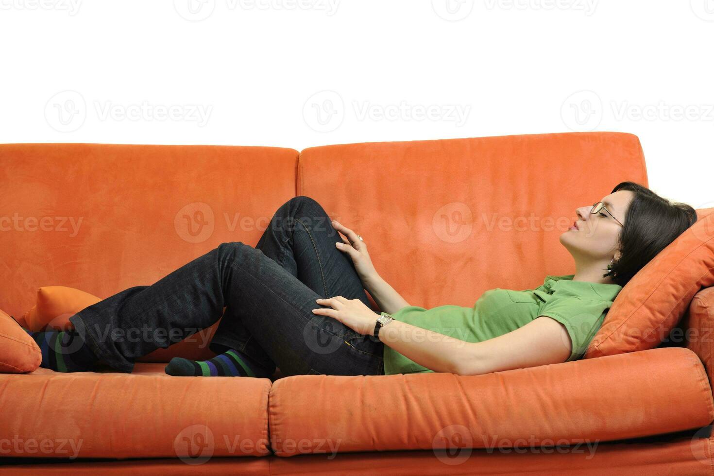 happy young woman relax on orange sofa photo