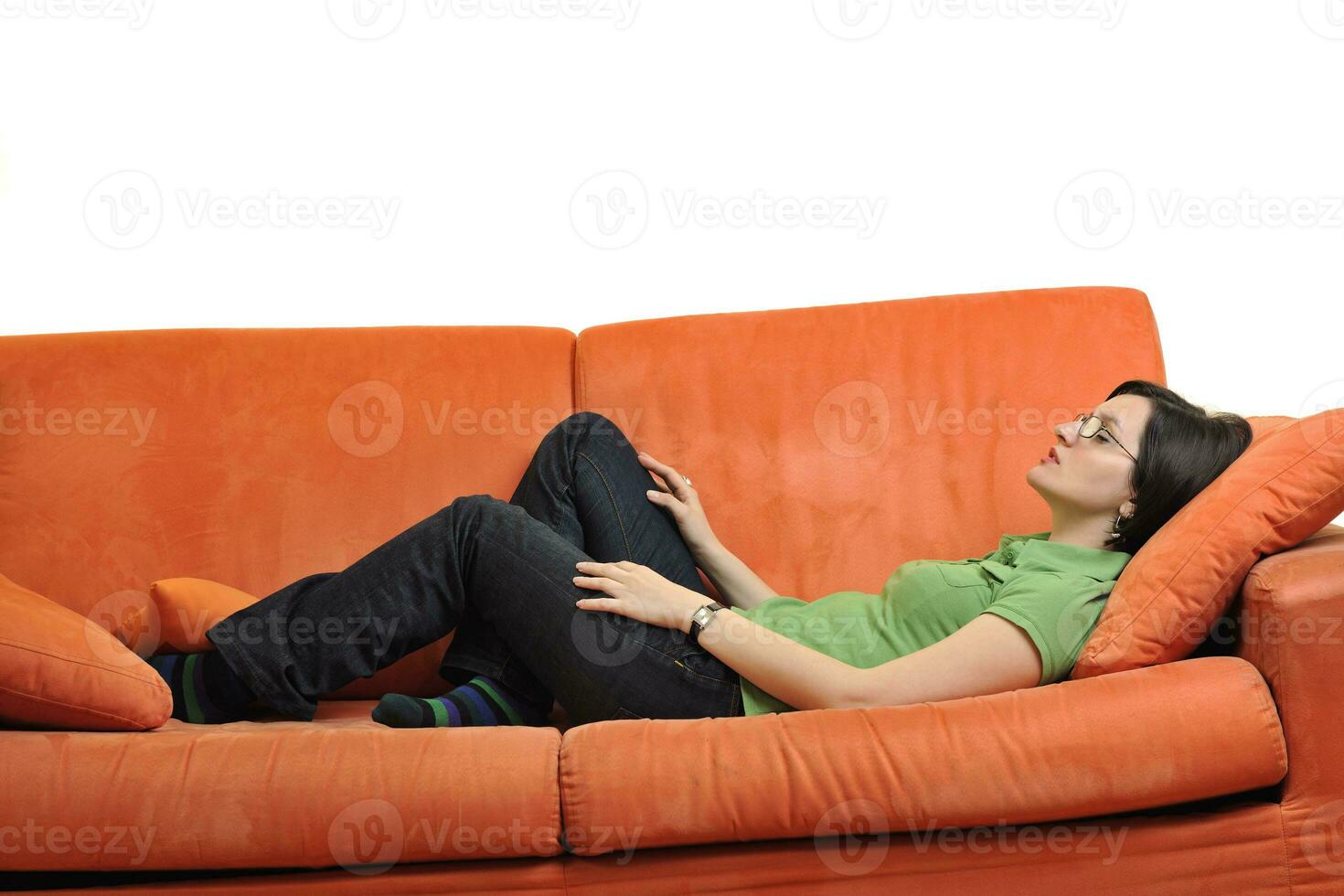 happy young woman relax on orange sofa photo