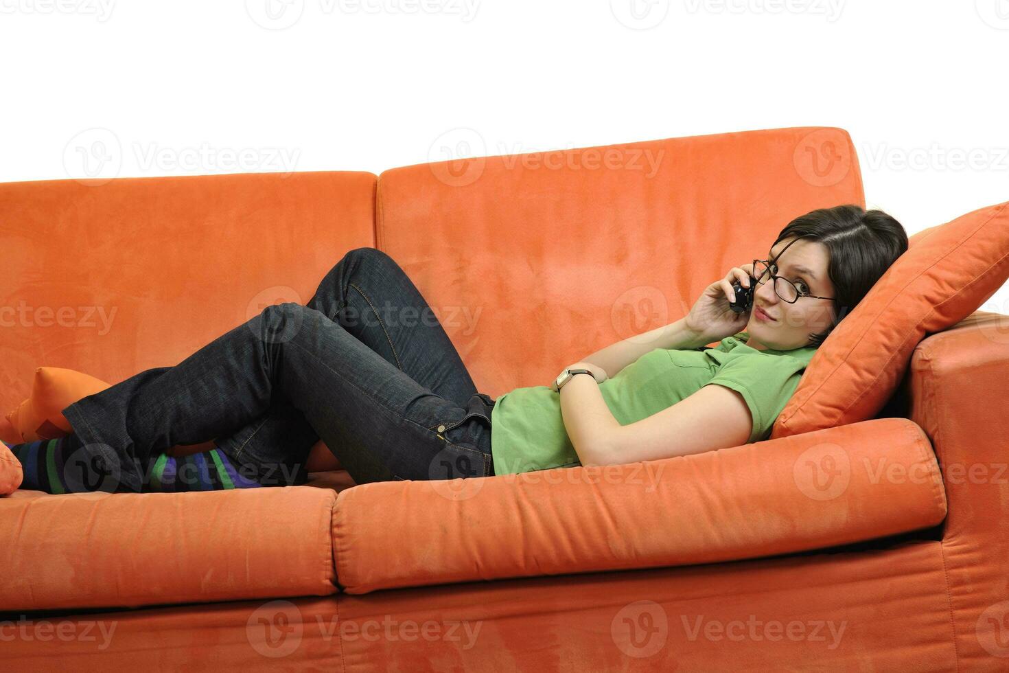 happy young woman relax on orange sofa photo