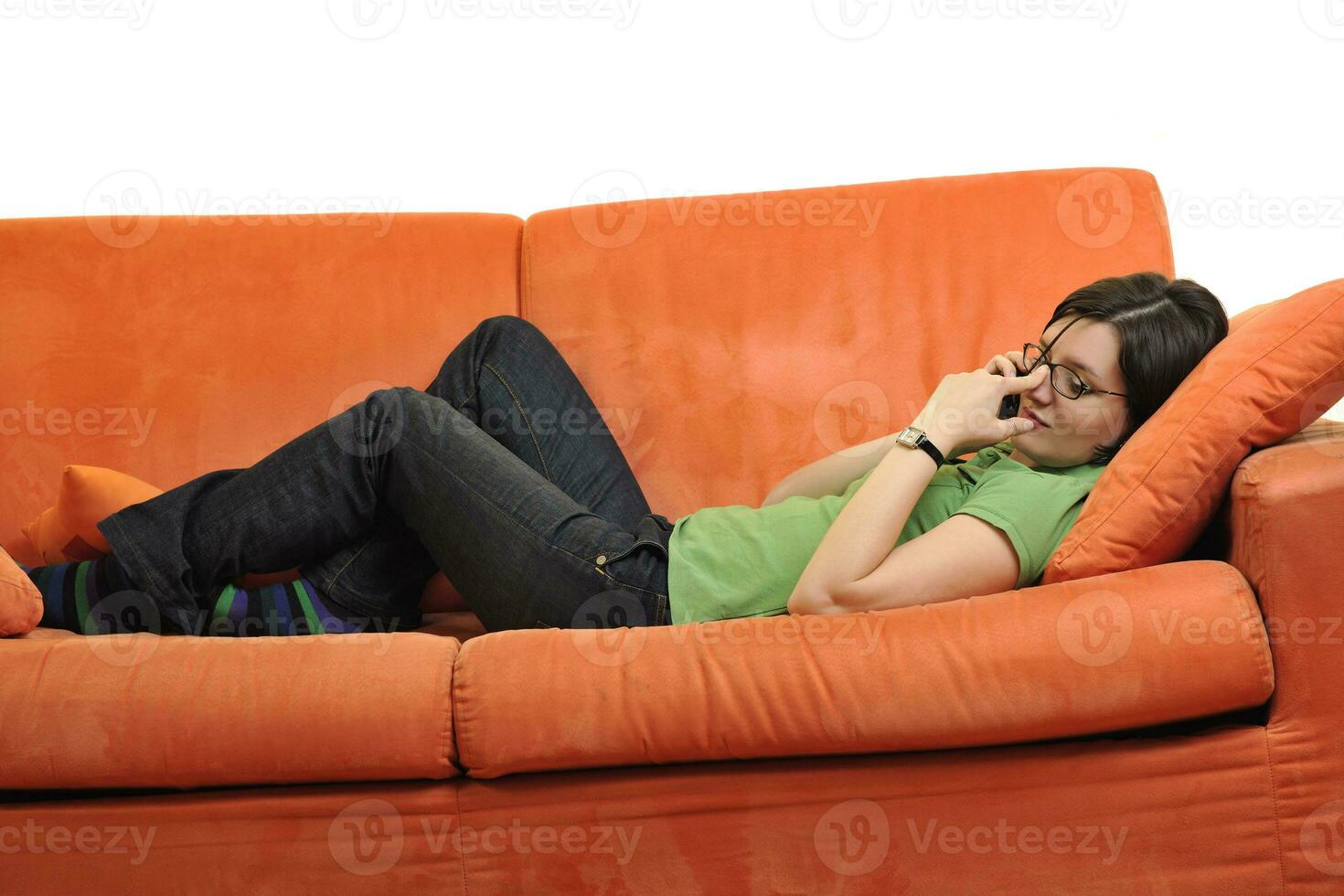 happy young woman relax on orange sofa photo