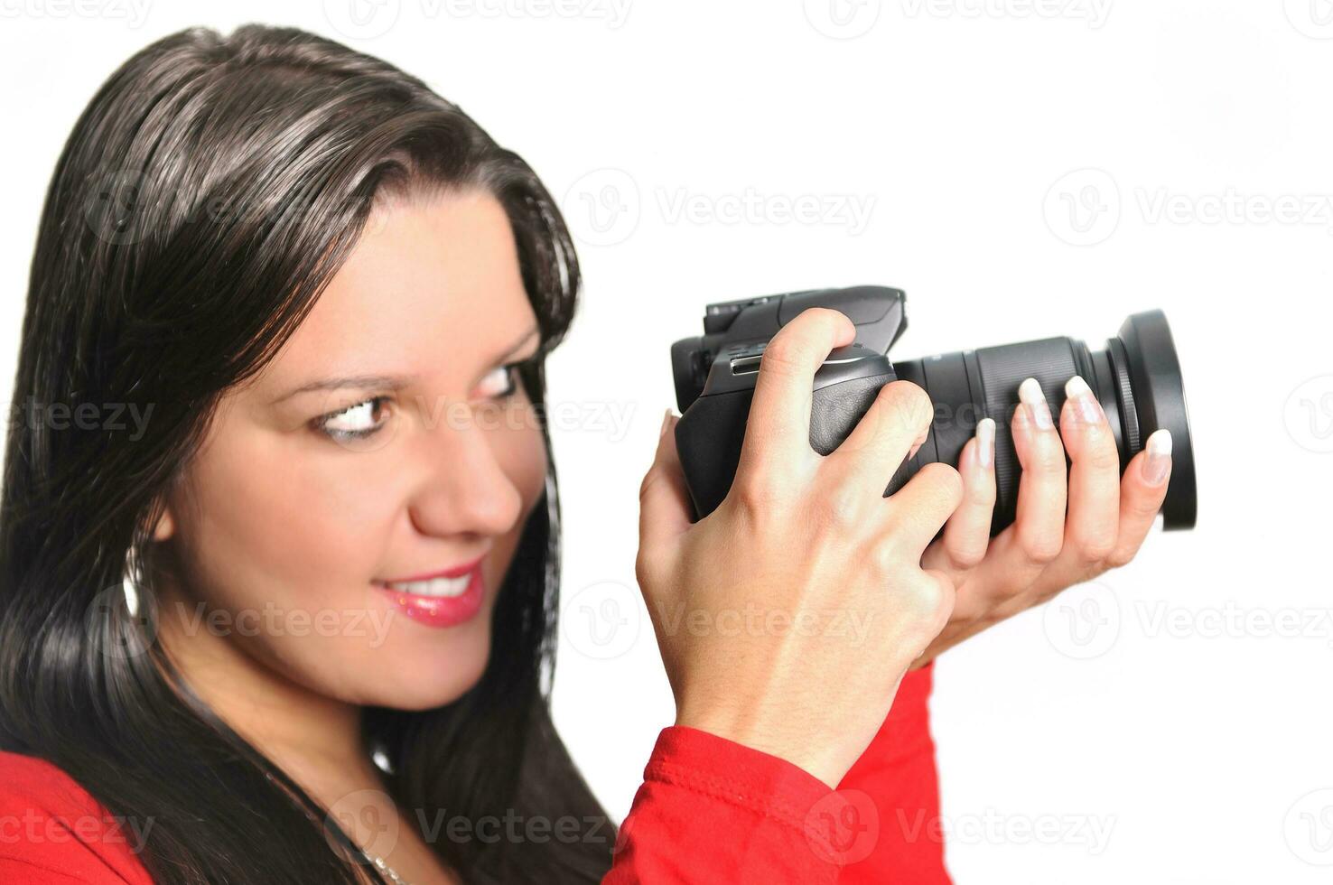 Young woman holding camera in hand taking picture isolated photo