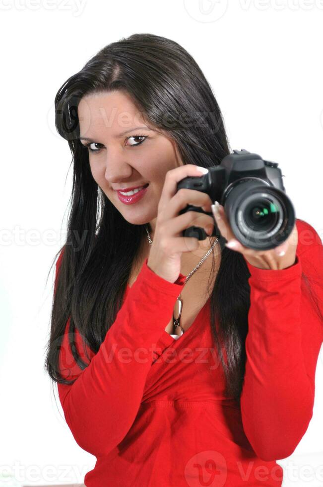 Young woman holding camera in hand taking picture isolated photo