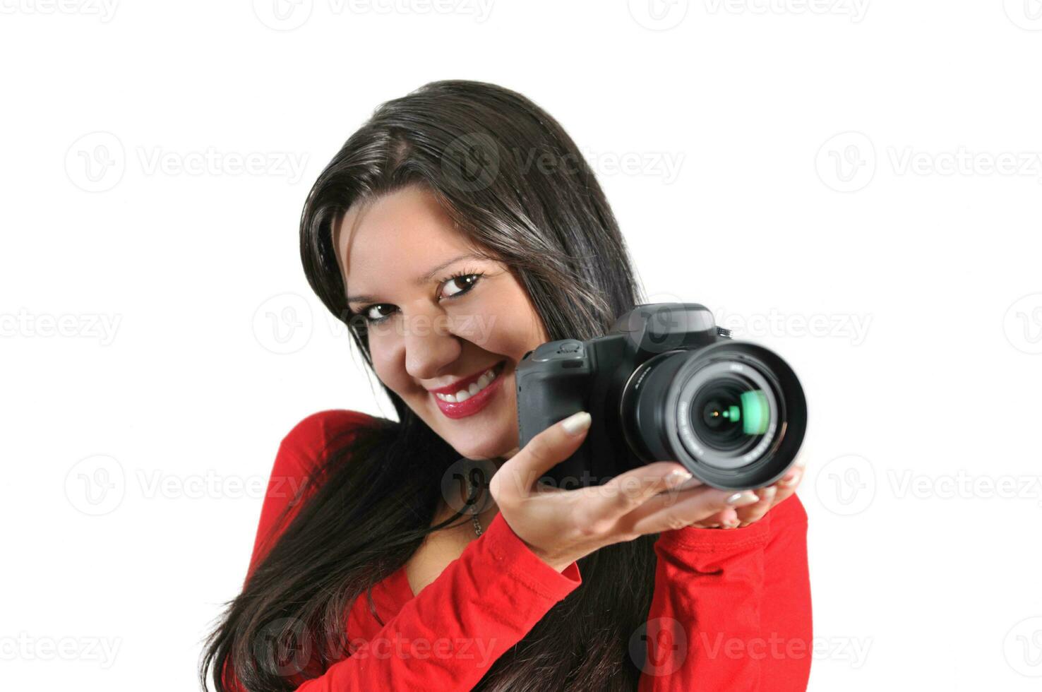 Young woman holding camera in hand taking picture isolated photo