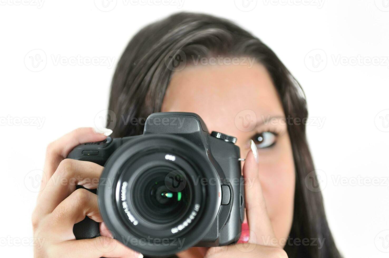 Young woman holding camera in hand taking picture isolated photo