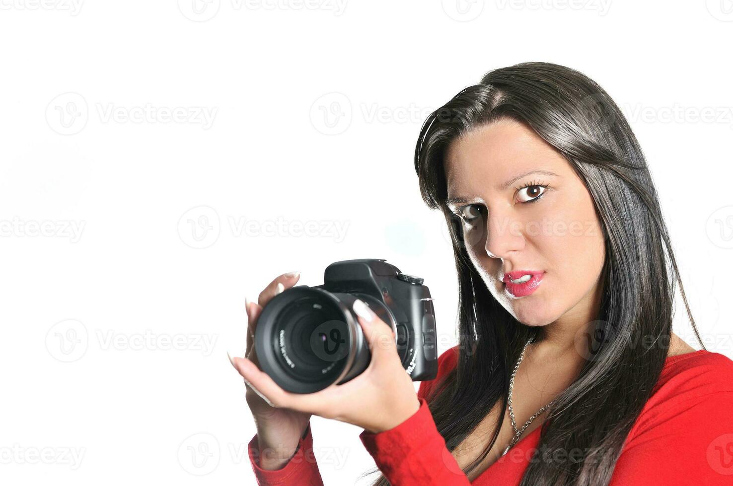 Young woman holding camera in hand taking picture isolated photo