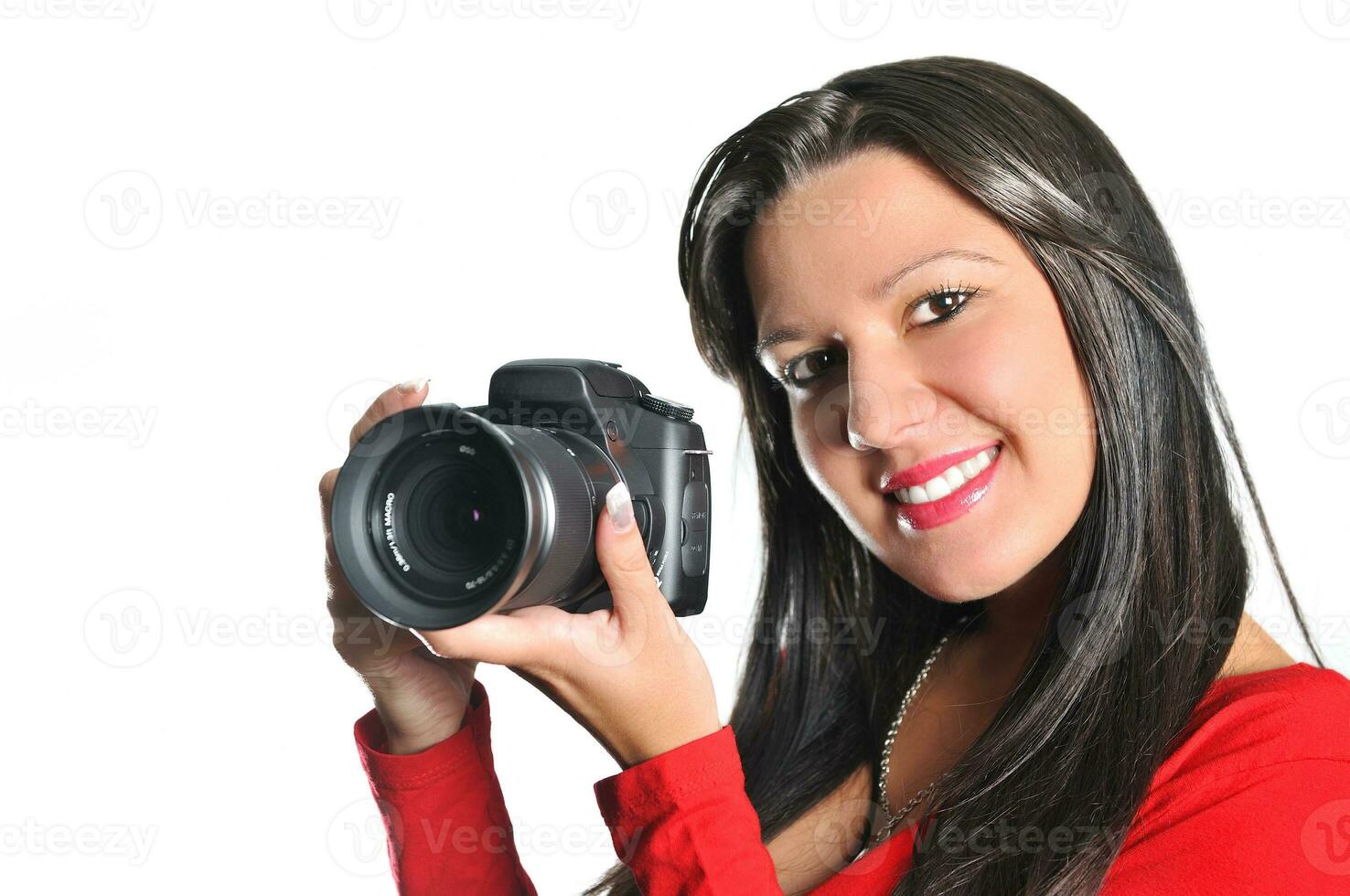 Young woman holding camera in hand taking picture isolated photo