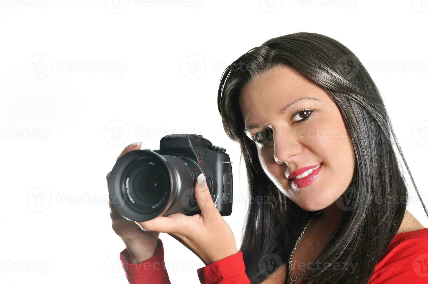 Young woman holding camera in hand taking picture isolated photo