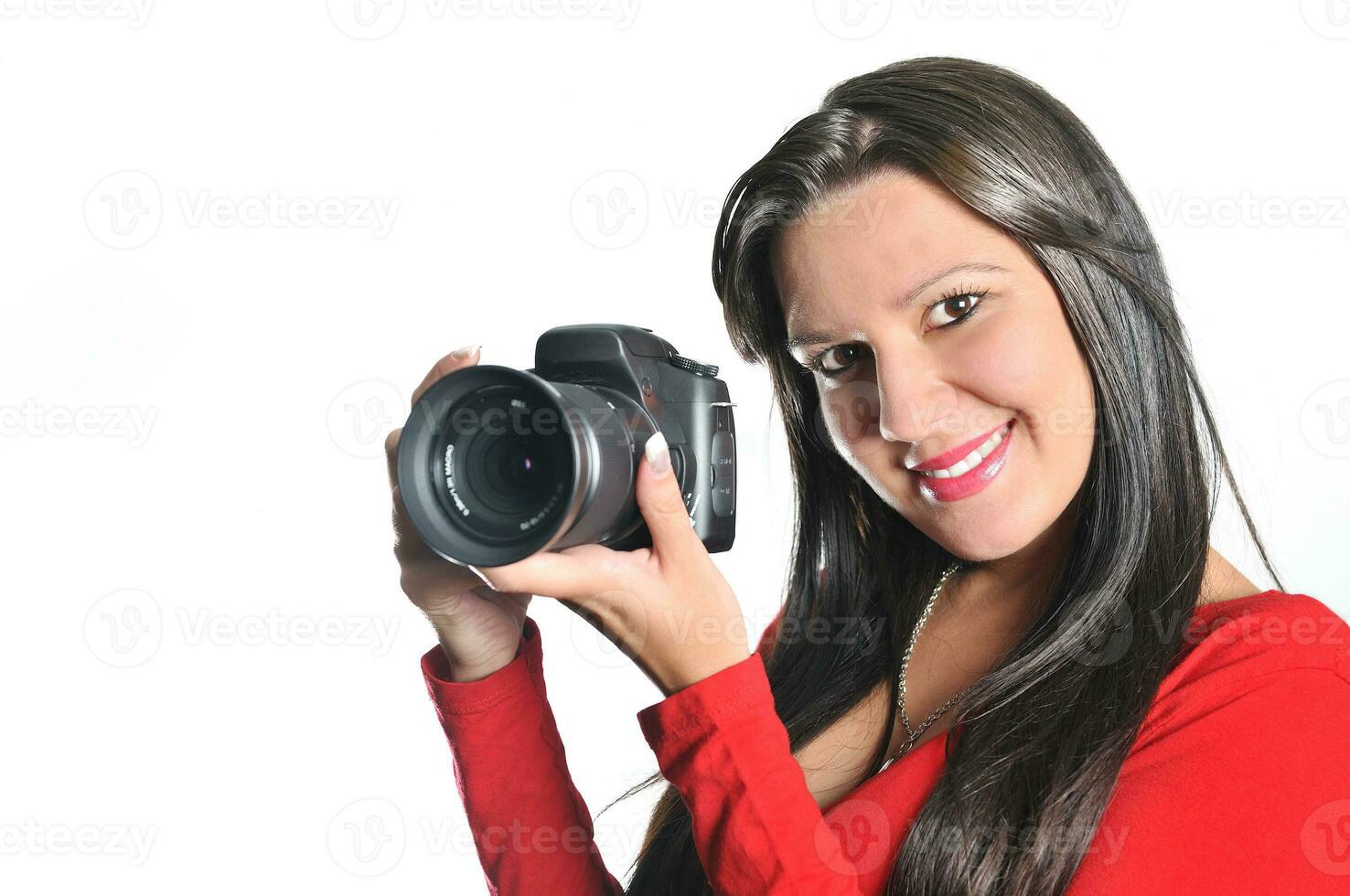 Young woman holding camera in hand taking picture isolated photo