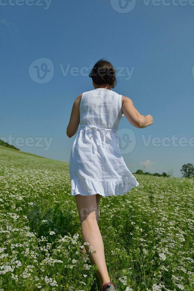 Young happy woman in green field photo