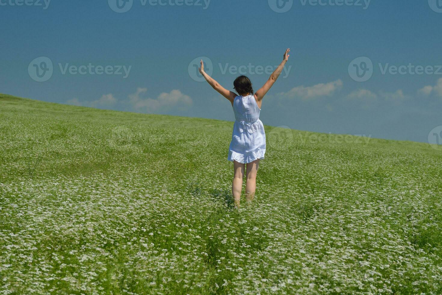 Young happy woman in green field photo